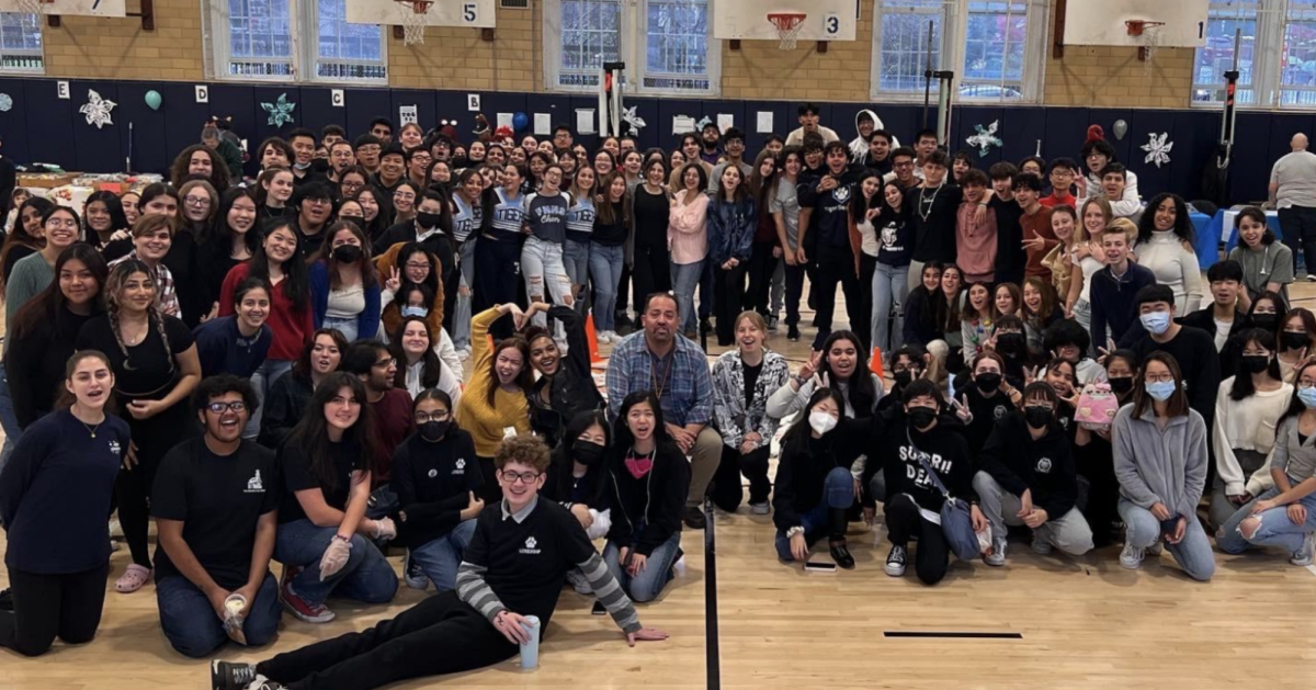 Students and staff conclude Fort’s first Winter Bazaar with one final group photo. Photo provided by Joseph Alvear.